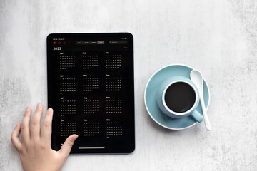 2023 calendar and a cup of coffee on the working table