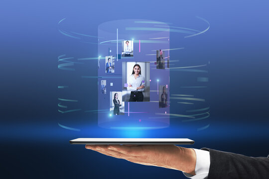 Close up of businessman hand holding tablet with abstract digital cylinder picture hologram on blue background. Computer, technology, innovation and media.