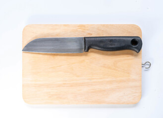 Wooden cutting board with knife on isolate white background.