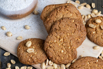 oatmeal cookies with peanuts on a black wooden table