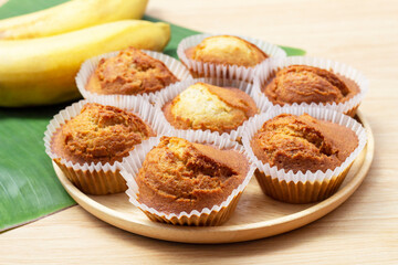 Sweet Banana muffins in wooden plate on the table.