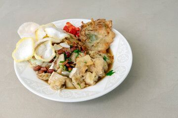 Kupat Tahu Magelang, is a traditional Indonesian food made from fried ketupat, tofu, cabbage and bean sprouts, mixed with peanut sauce and soy sauce. 45 deegree angle