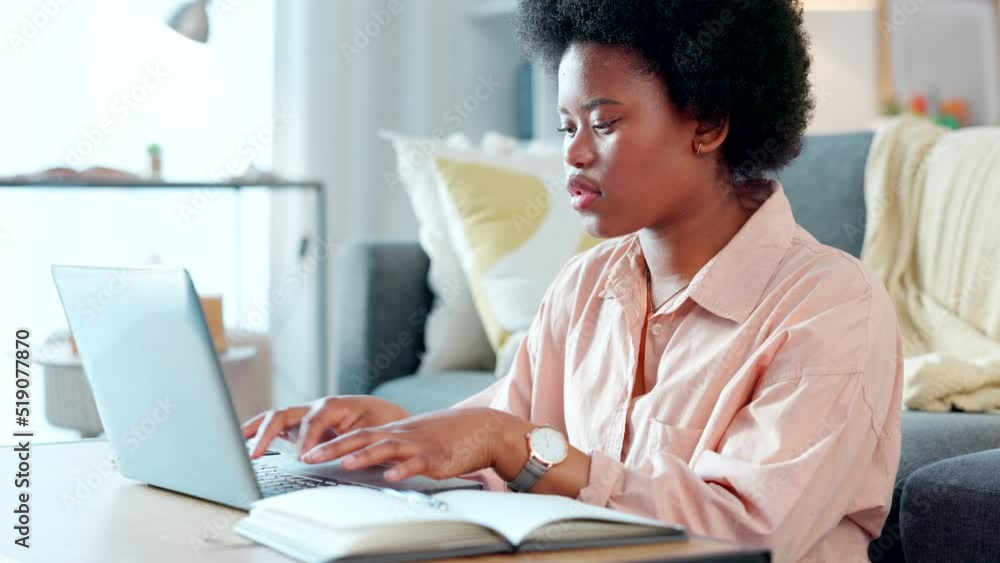 Poster focused female student typing an academic essay or working on homework assignment while sitting alon
