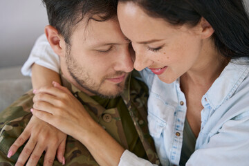 Tender moment between soldier and his wife