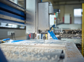 CNC machine cutting wood in factory