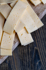 cut into pieces real hard cheese with lots of milk