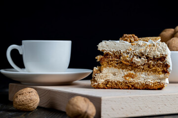 a piece of cake with buttercream and walnuts
