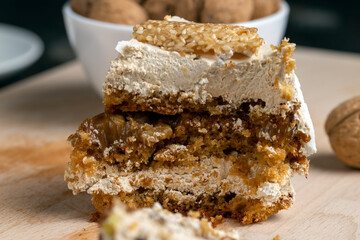 a piece of cake with buttercream and walnuts