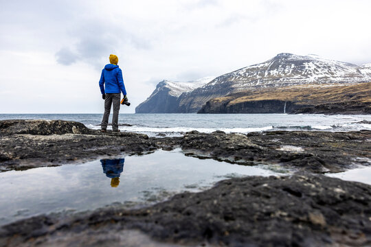 Faroe Islands, Eysturoy, Eidi, Male hiker admiring coastal landscape