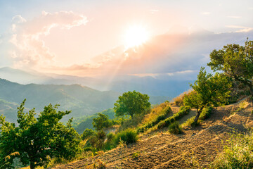 Mountain valley during sunset or sunrise. Natural spring or summer season landscape