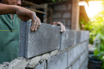 Close-up hands worker use brick block construction