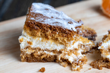 a piece of honey cake with vanilla cream and citrus tangerines