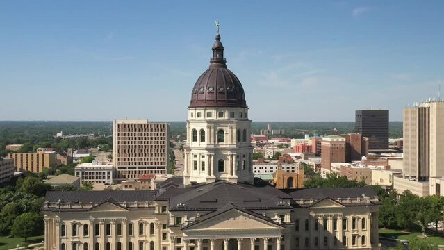 Kansas state capitol building in Topeka, Kansas close up with drone video moving down.