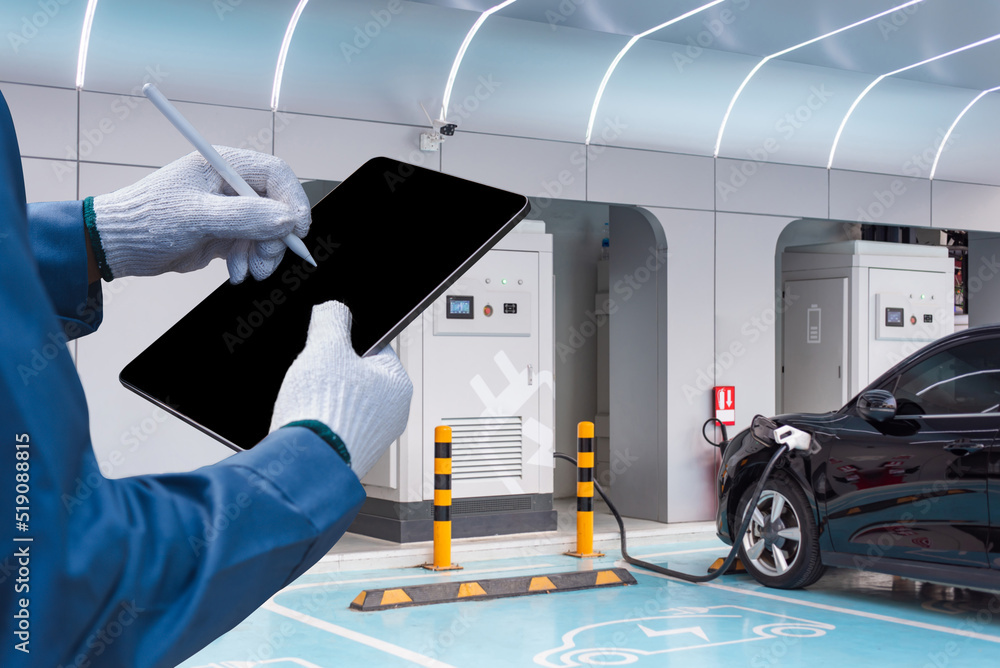 Poster car service technician or mechanic uses a tablet computer with a futuristic interactive diagnostics 