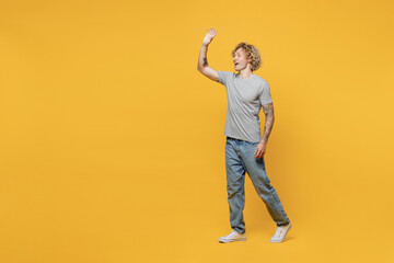 Full body young smiling happy friendly cheerful caucasian man 20s he wear grey t-shirt look camera...