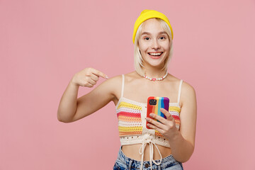 Young amazed blond lesbian woman she wear knitted top yellow hat hold use point index finger on...