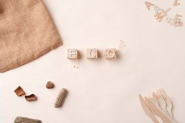Top view of reusable tectile bags, wooden scraps and ECO sign on the wooden cubes. Eco friendly accesories, zero waste concept.