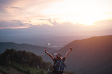 Happy woman with backpack hikes in the mountain with a beautiful view. Hikes mountain concept.