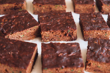 Delicious freshly baked vegan gluten free chocolate brownies made with natural ingridients such as almond flour, banana and zucchini. Sweet healthy food. Alternative sugar free snack.