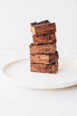 Delicious freshly baked vegan gluten free chocolate brownies made with natural ingridients such as almond flour, banana and zucchini. Sweet healthy food. Alternative sugar free snack.