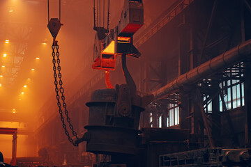Metallurgy plant interior. Foundry worker on big mold for iron cast. Heavy industry. Steel Mill.