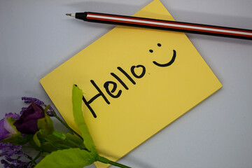 Close-up selected focus isolated Yellow Sticky note with hello greeting and smiley face written on...