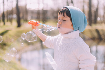 The boy blows soap bubbles lifestyle . Children's entertainment. Children's portrait.