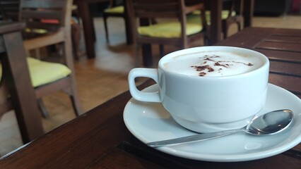 Hot milk coffee on wooden table.