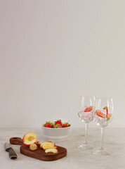 Fruit ingredients for preparing lemonade, coctail, sangria. Glasses with ice on the gray background with copy space
