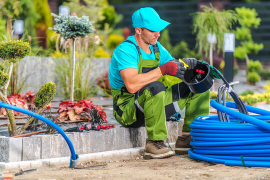 Garden Landscaper Building Backyard Irrigation System