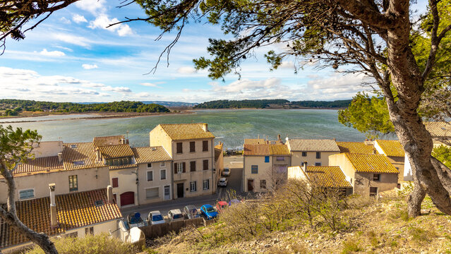 Old houses of the village of Gruissan with a lake in the background