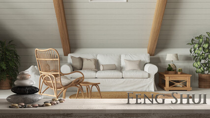 White table shelf with pebble balance and 3d letters making the word feng shui over bohemian living room with sofa in boho style. Mezzanine, zen concept interior design