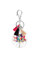 Close-up shot of a Tree of Life keychain decorated with colored stones, tassels and an owl pendant....