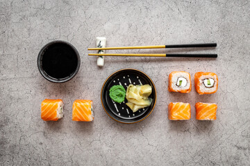 Sushi rolls set with salmon flatlay on table, top view
