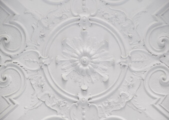 Fototapeta na wymiar Decorative item ceiling socket made of white plaster. Relief stucco interior