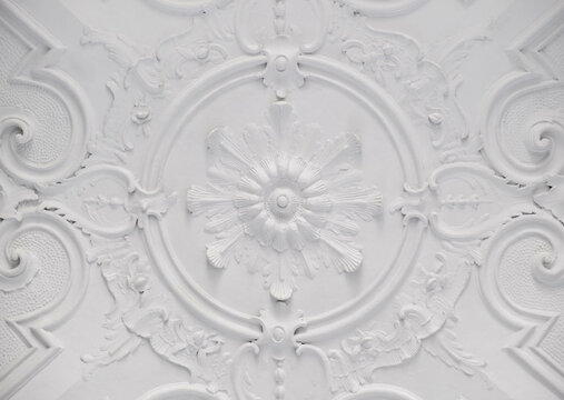 Decorative item ceiling socket made of white plaster. Relief stucco interior