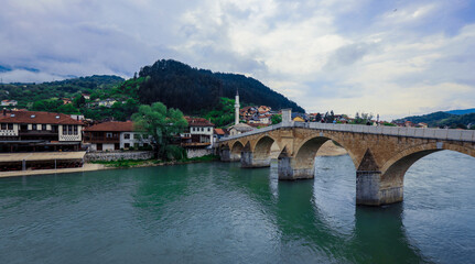 Fototapeta na wymiar View in the Rainy Day to the historic Mehmed Paša Sokolović Bridge Bridge in Višegrad, over the Drina River, Bosnia and Herzegovina