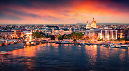 Obraz na płótnie Canvas Illuminated evening cityscape of Budapest, capital of Hungary, Europe. Colorful summer view of Chain Bridge and St. Stephen's Basilica Church. Traveling concept background.