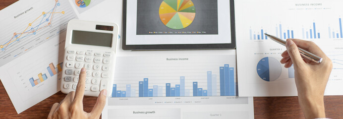 Business men analyze financial graphs and find break-even points for investments in order to reduce costs and reduce corporate taxes, Analysis of financial accounting and real estate investment.