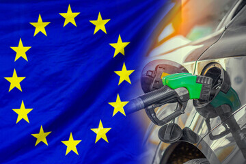 Car with a fuel injector on EU flag background. Record prices fuel for population. Gasoline price increase during energy and fuel world crisis in European Union