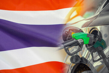 Car with a fuel injector on Thailand flag background. Record prices fuel for population. Gasoline...