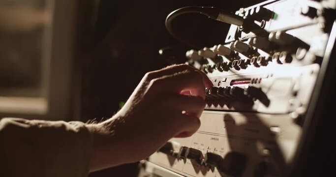 Musician tuning amplifier in studio