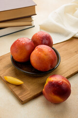 peaches nectarines with water drops on a wooden board