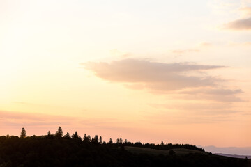 Beautiful sunset landscape with mountains and trees