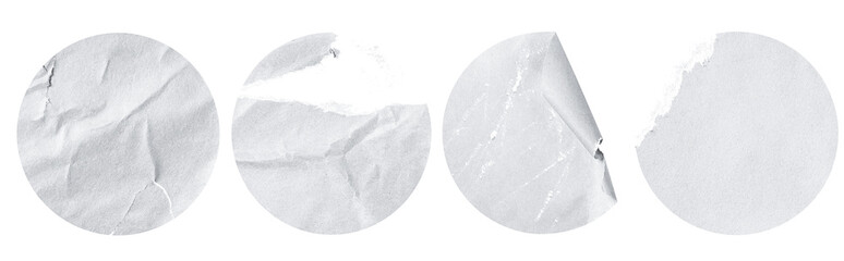four white damaged, torn, round stickers on a white isolated background