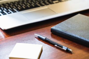 Work desk with a laptop, pencil, diary and note pad