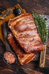 Meat restaurant kitchen. Smoked BBQ Pork Ribs on wooden cutting board. Wooden background. Top view