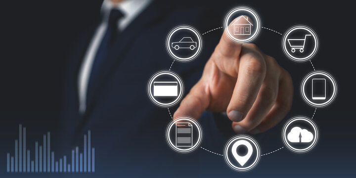 Businessman touches house icon on a virtual screen interface