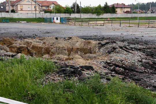 A hole in the ground from a cannon explosion of a Russian shell in the Kyiv region in Ukraine 2022. A crater from shelling in a vegetable garden in a Ukrainian village