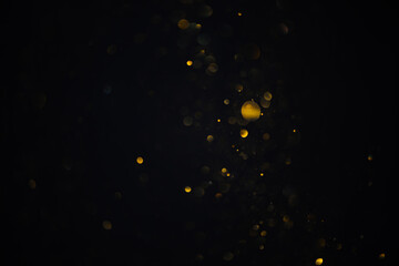 Few golden glitter bokeh sparkles shiny lights dark abstract overlay background